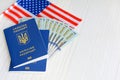 Many hundred dollars and two Ukrainian blue passports. Immigration to the United States concept. Ukrainian foreign passport. Royalty Free Stock Photo