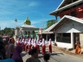 Many Indonesian students walking on the street with uniforms and decorated flag in celebrating the country's Independece Day.