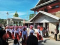 Many Indonesian students walking on the street with uniforms and decorated flag in celebrating the country's Independece Day.