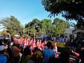 Many Indonesian students walking on the street with uniforms and decorated flag in celebrating the country's Independece Day.