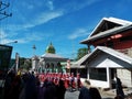 Many Indonesian students walking on the street with uniforms and decorated flag in celebrating the country's Independece Day.