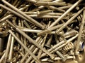 Many iron fasteners laying on top of each other in a pile