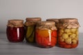Many jars with preserved vegetables on white wooden table Royalty Free Stock Photo
