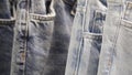 Many jeans hanging on rack. Row of pants denim jeans hanging in closet, concept of buy , sell , shopping and jeans fashion