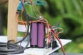 Many jumper wires are connected to breadboard and controller along with a battery and sensor module for building electronics