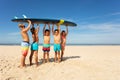 Many kids carry surfboard on the beach to sea Royalty Free Stock Photo