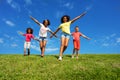 Many kids with hands in flying pose run down hill Royalty Free Stock Photo