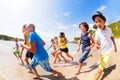 Many kids having fun racing on the sunny beach Royalty Free Stock Photo