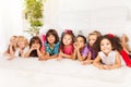 Many kids in a row on the floor at home Royalty Free Stock Photo