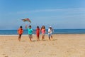 Many kids run on the beach with color kite Royalty Free Stock Photo