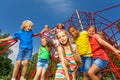 Many kids stand on red ropes together in park Royalty Free Stock Photo