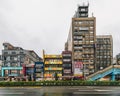 Many kinds of buildings on the empty street of Taipei while raining in the dusk