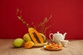 Many kinds of fruit with some dried candy on a dish and a tea set placed Royalty Free Stock Photo