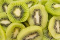 Many kiwi slices are placed in a glass crisper. Kiwifruit slices without peel