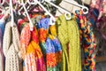Many knitted scarves hang on the hanger
