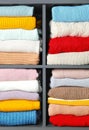 Many knitted winter clothes stacked