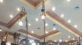 Many lamps hanging on the ceiling. An artistic ceiling with blue-gold color