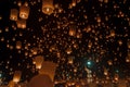 Many lanterns float in the night sky.