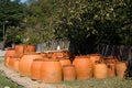 Many large earthenware jugs for wine are sold near the road