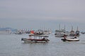 Many Large Tourist Junk Boats without sail scattered at Halong Bay off Bai Chay Tourist Wharf