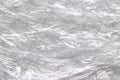 Many layered cellophane plastic wrinkle clear surface with creases for macro light gray abstract wallpaper and background Royalty Free Stock Photo