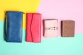 Many leather purses on a colored pastel background. Top View.