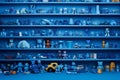 Many little blue objects arranged neatly in rows on shelves, collection of weird little funny objects, generative AI