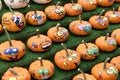 Many little funny painted pumpkins