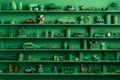 Many little green objects arranged neatly in rows on shelves, collection of weird little funny objects, generative AI Royalty Free Stock Photo