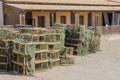 Many lobster or crayfish traps stacked in front of old building, Luderitz, Namibia, Southern Africa Royalty Free Stock Photo