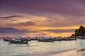 Many long boats are floating in the sea with amazing beautiful summer sunset view at Lipe beach thailand.