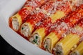 Many manicotti on a white dish plate Royalty Free Stock Photo