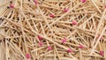 Many matches with brown and rose match heads scattering on rows