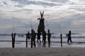 Many men carry the Straw Scarecrow into the water during a ceremony for good weather and good fishing, at sunset