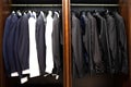 Many men`s suits on a hanger in the store Royalty Free Stock Photo