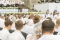 Many men and women pray to Jesus. Christian choir of young men and girls in the park sing Christian songs and glorify God. blurry