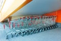 Many metal shopping carts on a parking lot near supermarket outdoors Royalty Free Stock Photo