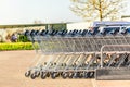 Many metal shopping carts on a parking lot near supermarket outdoors. Shopping concept Royalty Free Stock Photo