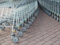 Many metal shopping carts on a parking lot near supermarket outdoors Royalty Free Stock Photo