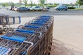 Many metal shopping carts a parking lot near supermarket outdoors Royalty Free Stock Photo