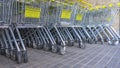 Many metal shopping carts on a parking lot near supermarket outdoors. Shopping concept. Shopping carts outside. Royalty Free Stock Photo