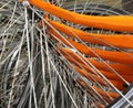 many metallic spokes of orange bicycle