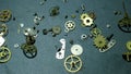 Many metallic watchmaking parts on black surface