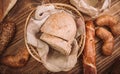 Many mixed baked breads and rolls on rustic wooden table Royalty Free Stock Photo