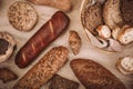 Many mixed baked breads and rolls on rustic wooden table Royalty Free Stock Photo