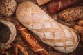 Many mixed baked breads and rolls on rustic wooden table Royalty Free Stock Photo