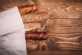 Many mixed baked breads and rolls on rustic wooden table Royalty Free Stock Photo