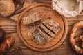 Many mixed baked breads and rolls on rustic wooden table Royalty Free Stock Photo