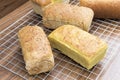 Many mixed homemade breads loaf on wood table