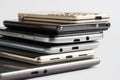 Many mobile phones of different generations and an electronic tablet on a white background. Modern digital gadgets. Micro USB and